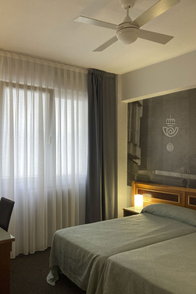 Habitación doble del Hotel Photo Zabalburu con dos camas individuales, ventilador de techo y luz natural